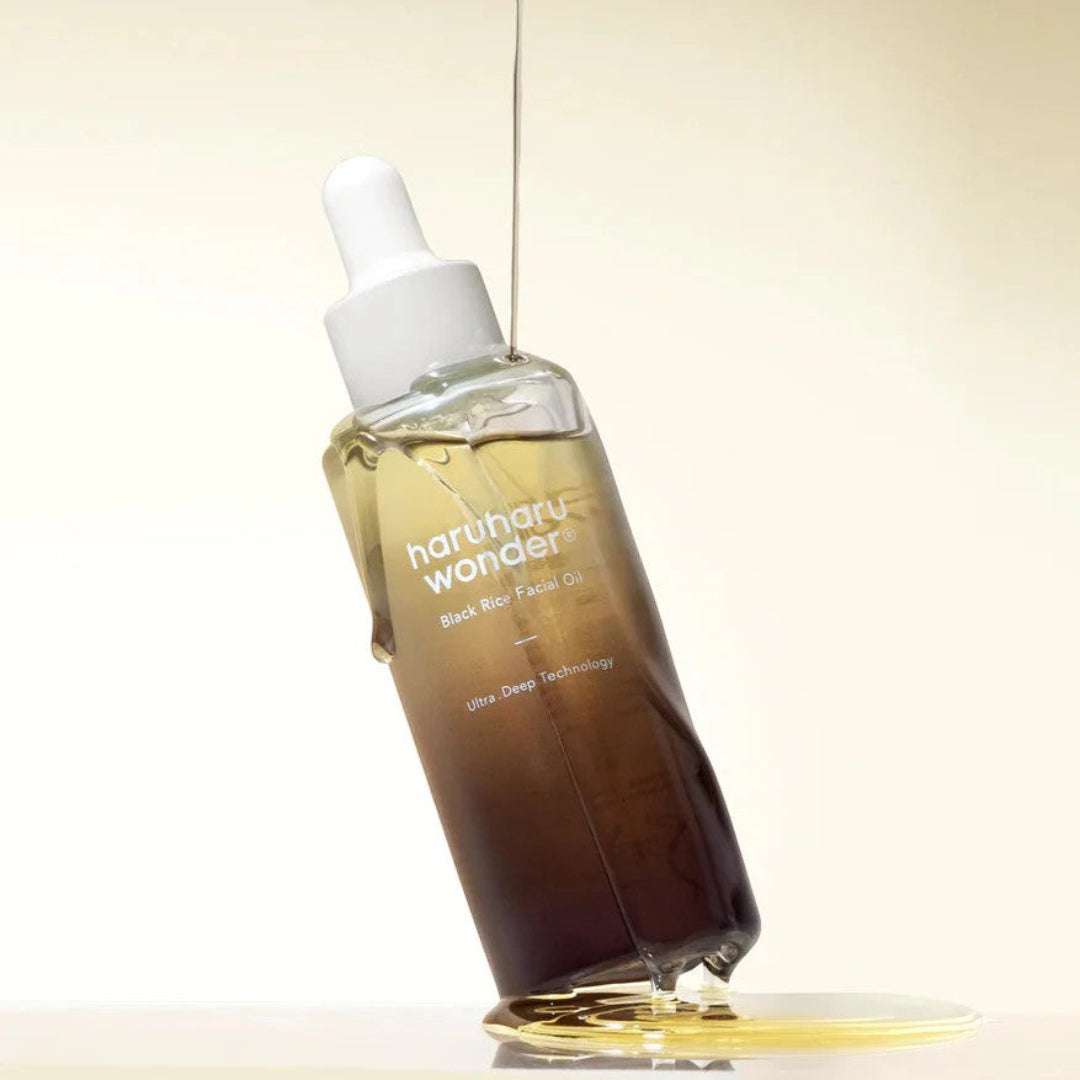 Bottle of 'harmony wonder' black rice facial oil with dropper on a light background