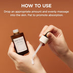 Hand holding a dropper with a bottle labeled 'Centella' against a brown background