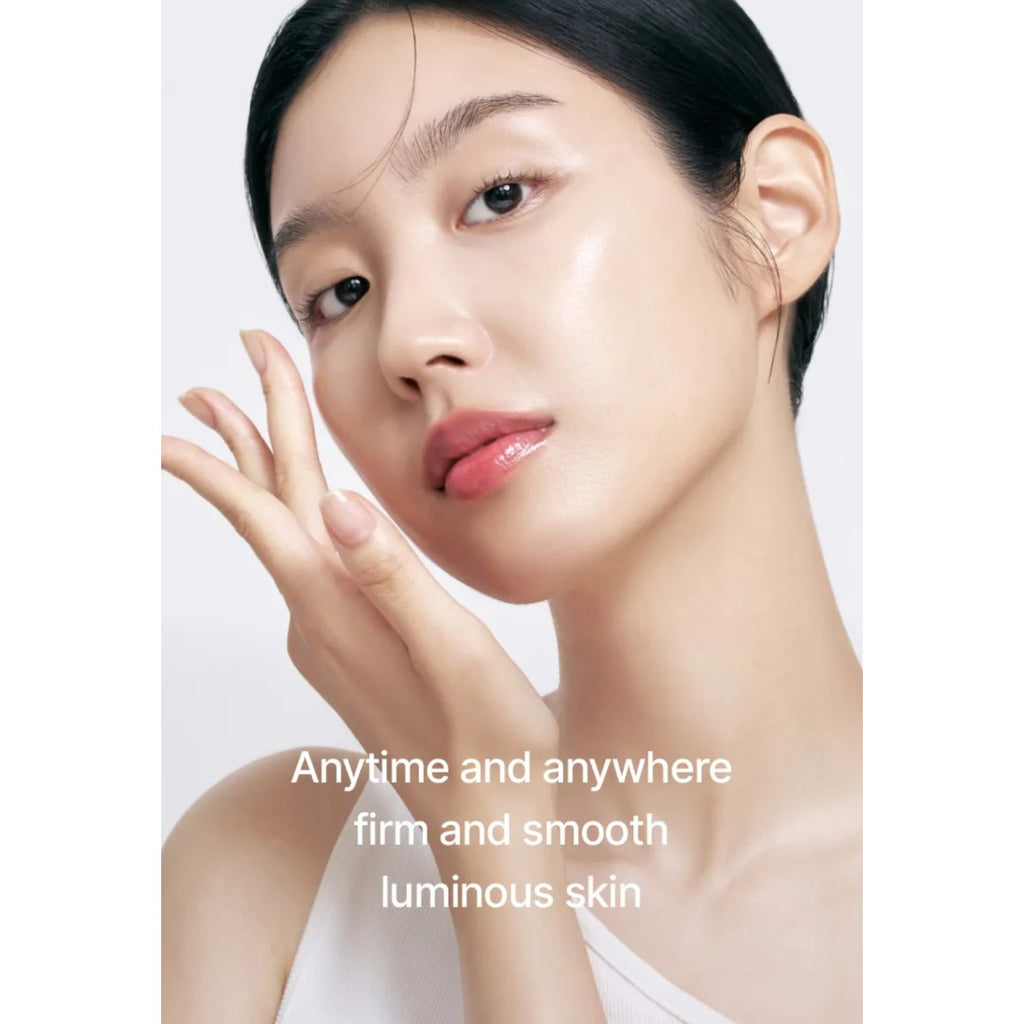 Woman with smooth skin touching her face against a white background