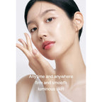 Woman with smooth skin touching her face against a white background